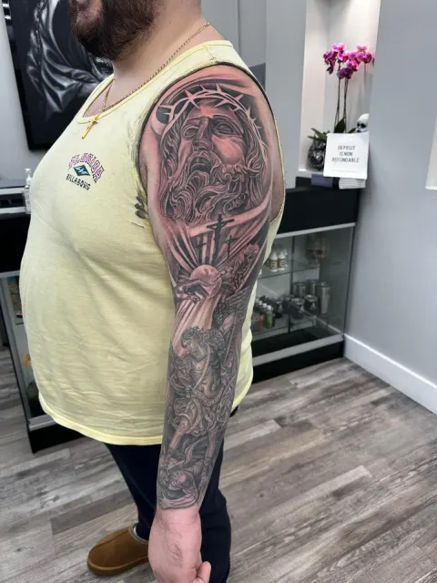 Black and grey upper-arm portrait of Christ crowned with thorns