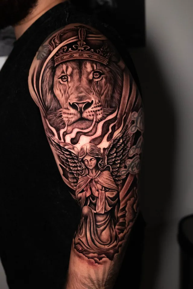 Black and grey realism tattoo combining a lion portrait and winged angel
