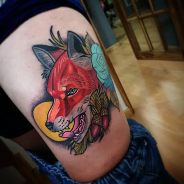 Color thigh tattoo of a red fox head framed by a teal rose and autumn leaves