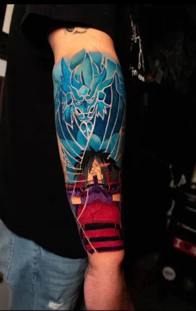 Color forearm tattoo of a crystalline blue fox spirit above a red torii gate