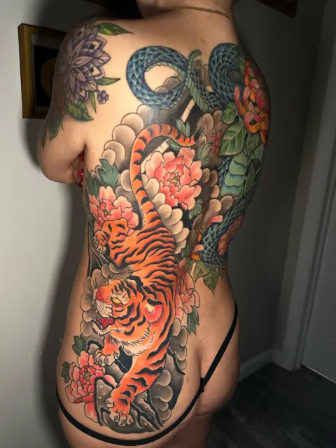 Full-back neo-oriental tattoo of two tigers and a serpent moving through chrysanthemums